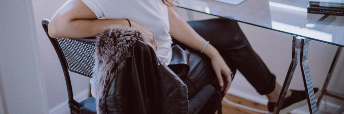 The Designer Edit by WEST 14TH: black leather slouch pants with a shearling jacket, seated