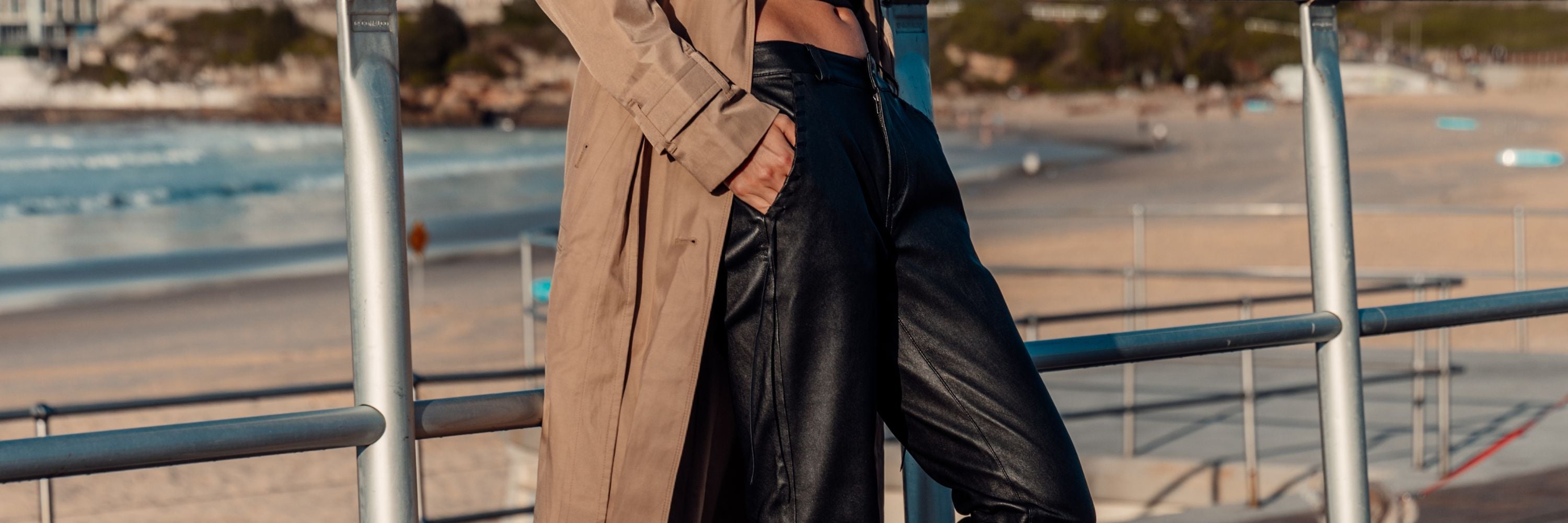 women wearing slouch leather black pants at bondi beach